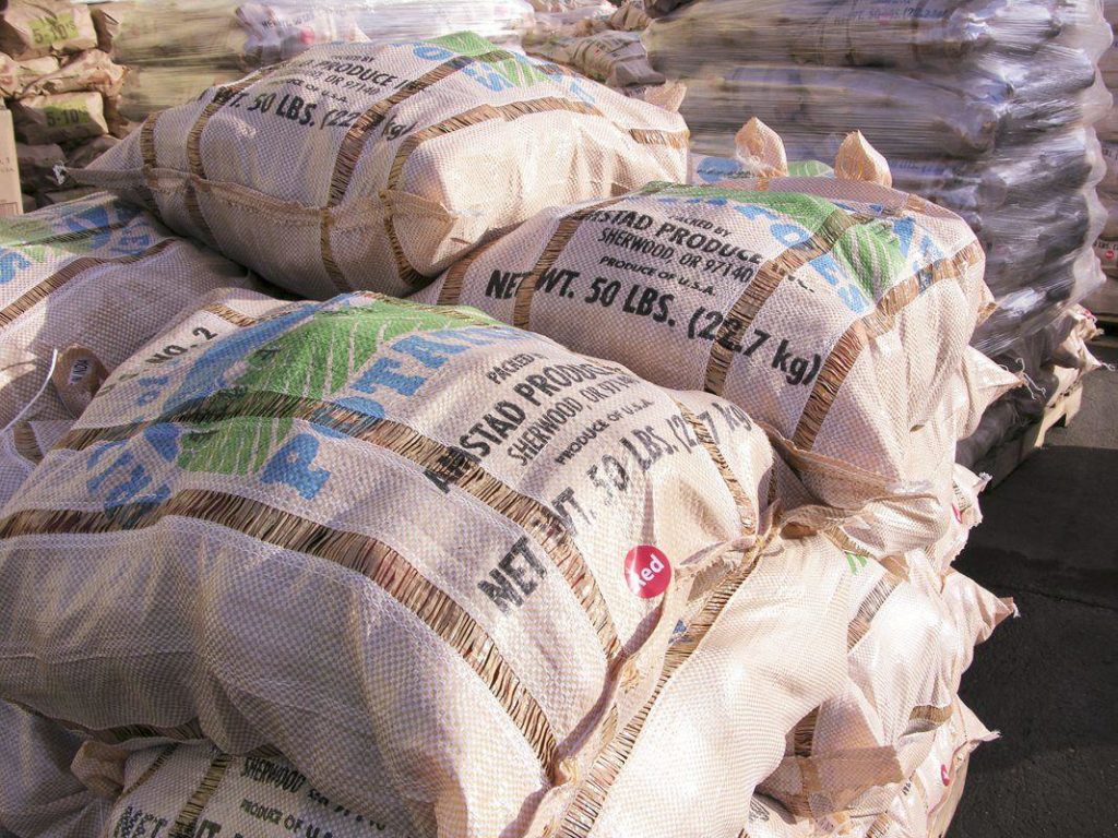 Sacks of potatoes destined for local food banks are stacked at Amstad Produce in Sherwood, Ore. With the coronavirus leaving many people out of work, food banks are scrambling to meet the surge in demand. Organizations such as Farmers Ending Hunger are stepping up  donations to the Oregon Food Bank and its affiliates across the state.